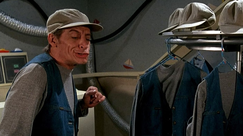 Felix stands among Ernest's outfits in "Ernest Goes to Jail" (1990)