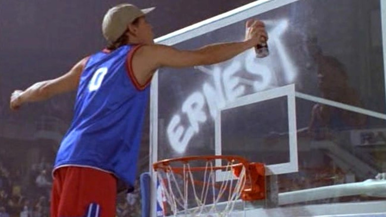 Ernest spray-paints his name on the backglass in "Slam Dunk Ernest"
