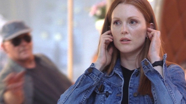 Clarice on the phone, with Hannibal in the background, in "Hannibal."
