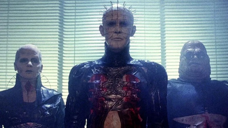 Cenobite trio standing in front of window in Hellraiser (1987)