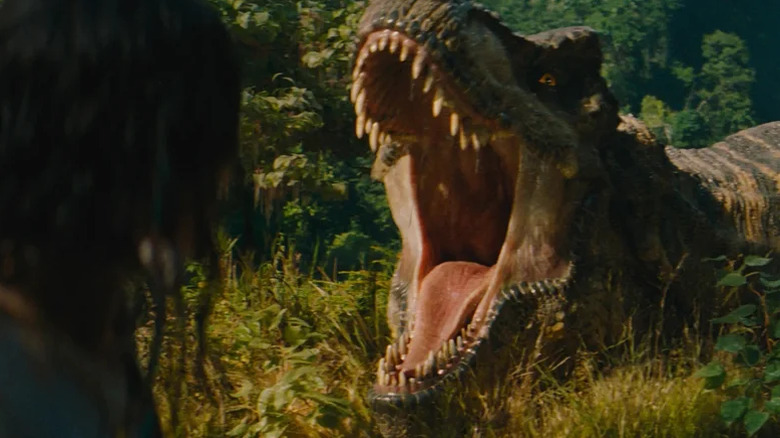 A T-rex roars through the forest in Jurassic World Rebirth (2025)