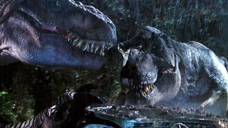 Two T-rex dinosaurs smash into a trailer in The Lost World: Jurassic Park (1997)