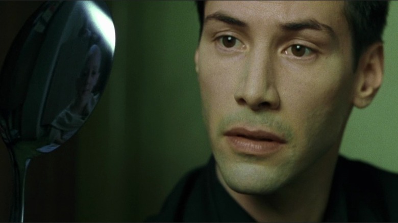 Neo looks at a bending spoon in "The Matrix" (1999)