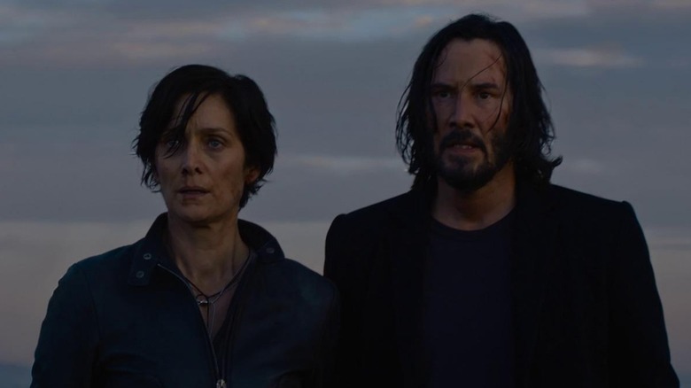 Neo and Trinity stand on a roof in "The Matrix Resurrections" (2021)