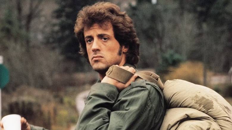 John Rambo looks forlorn carrying a backpack in First Blood (1982)