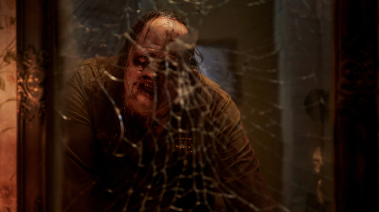 Leatherface looking in a shattered mirror in "Texas Chainsaw Massacre."