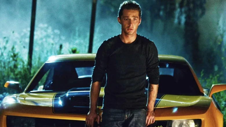 Sam Witwicky stands at Bumblebee's hood in "Transformers" (2007)