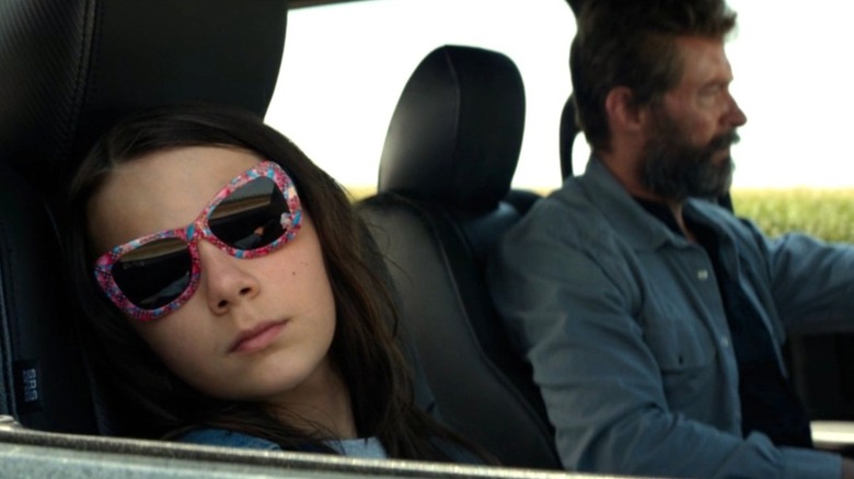 Laura staring out the car window as Logan drives in "Logan" (2017)