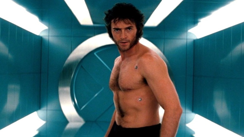 Shirtless Wolverine runs through the X-Mansion hall in "X-Men" (2000)