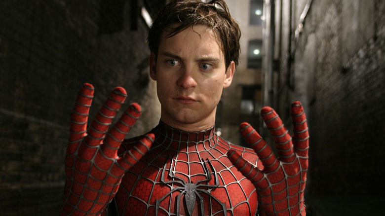 Maskless Spider-Man looking at his hands