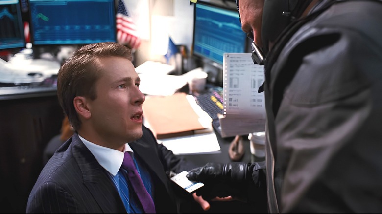 stock broker looks at Bane