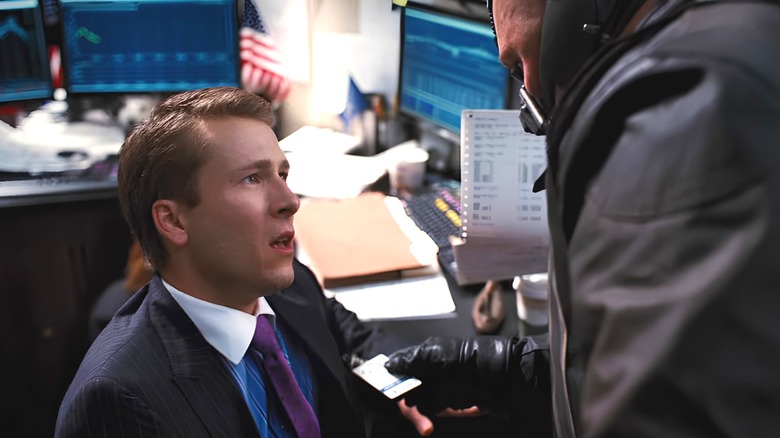 stock broker looks at Bane