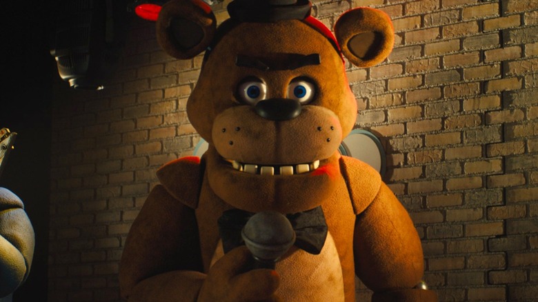 Freddy Fazbear holding a microphone