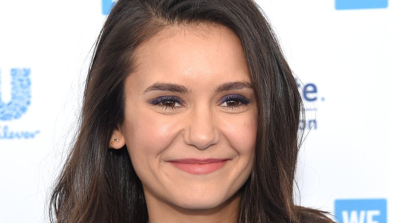 Nina Dobrev smiling at event