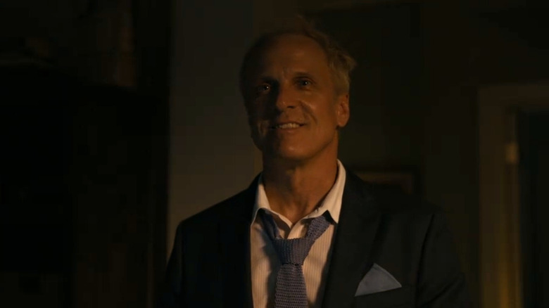 Patrick Fabian smiles in darkness as Howard Hamlin on Better Call Saul