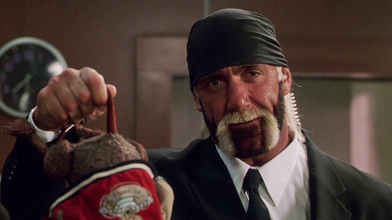 Hulk Hogan holds a muppet rat by its tale in Muppets in Space