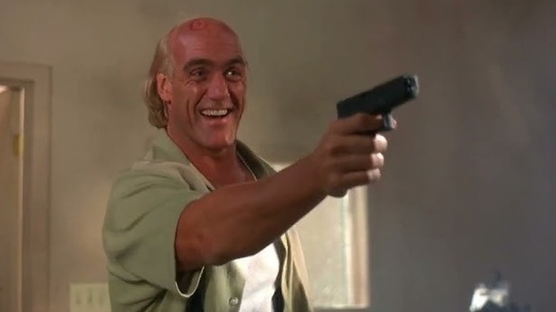 Chase smiles and aims a pistol in Secret Agent Club