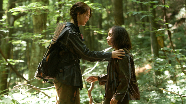 Katniss talking to Rue in the woods in The Hunger Games