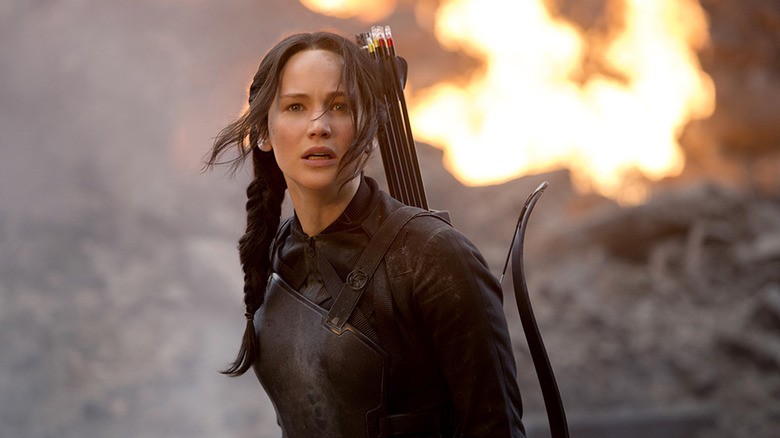 Katniss looking shocked in front of an explosion in The Hunger Games: Mockingjay — Part 1