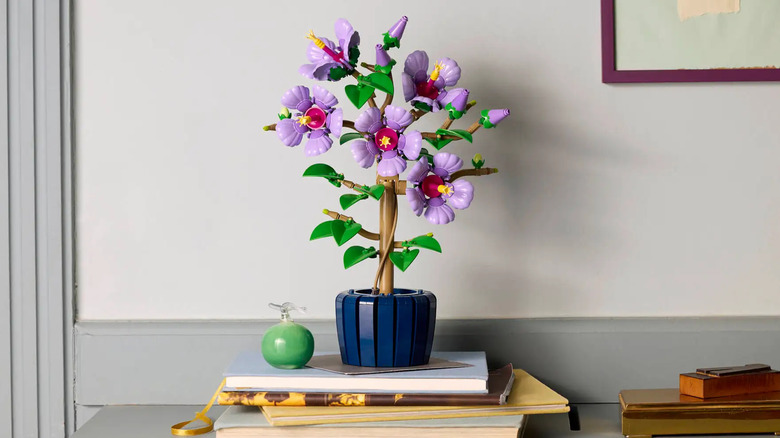 LEGO Hibiscus sitting on top of books