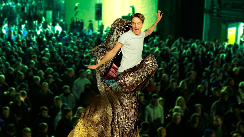 Man getting swallowed by dinosaur in front of audience