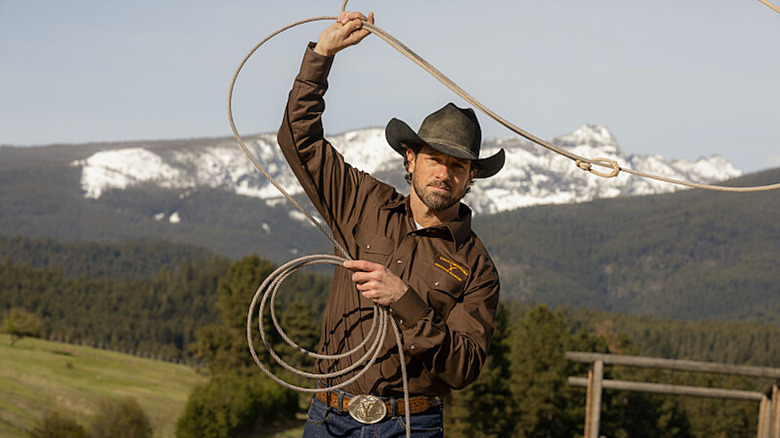 Ryan wearing cowboy hat and lassoing his rope