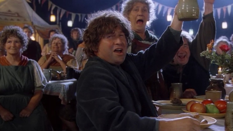 Hobbits cheering at Bilbo's birthday party in The Fellowship of the Ring