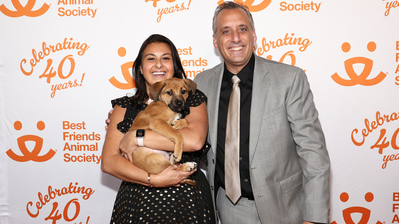 Joe and Bessy Gatto pose with their dog on the red carpet