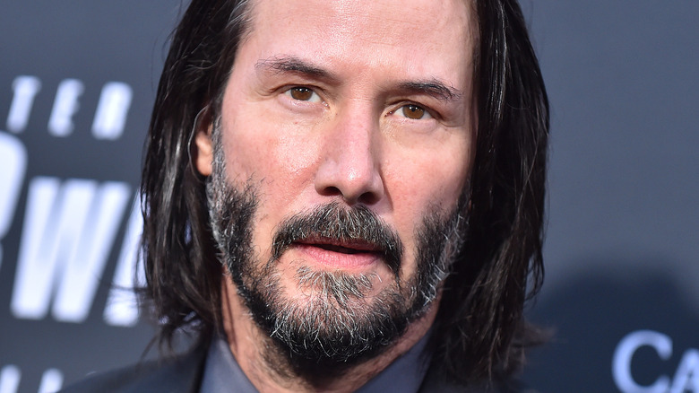 Keanu Reeves looking into camera 