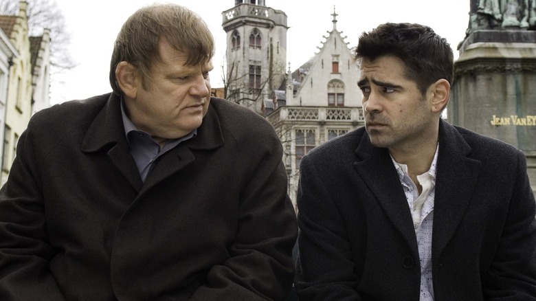 Colin Farrell and Brendan Gleeson on a city bench 