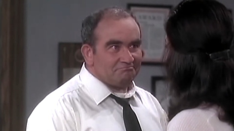 Lou Grant smirks at Mary Richards