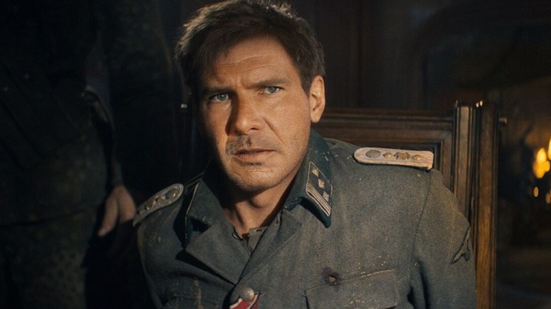 Indiana Jones sits in a military uniform in Indiana Jones and the Dial of Destiny (2023)