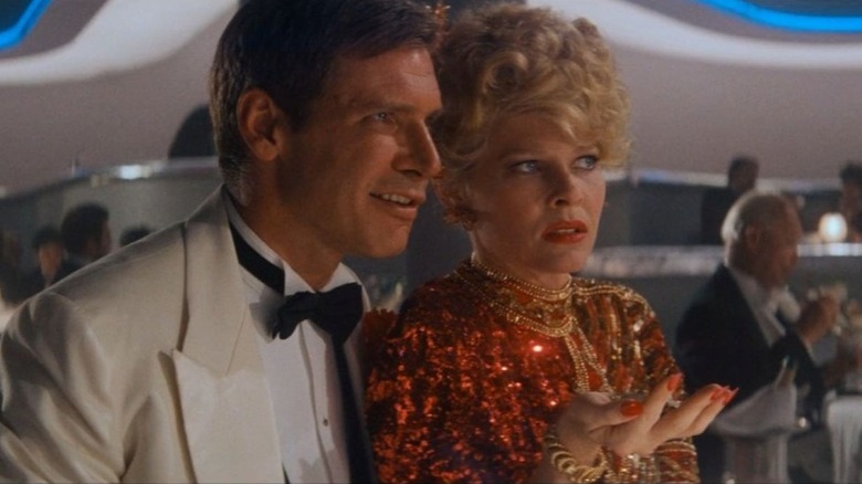 Indiana Jones sits next to Willie Scott in a nightclub in Indiana Jones and the Temple of Doom (1984)