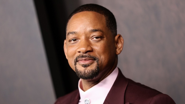 Will Smith smiling in maroon jacket