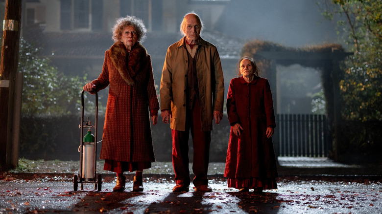 The acolytes stand on the street in "Insidious: Out of the Further" (2026)