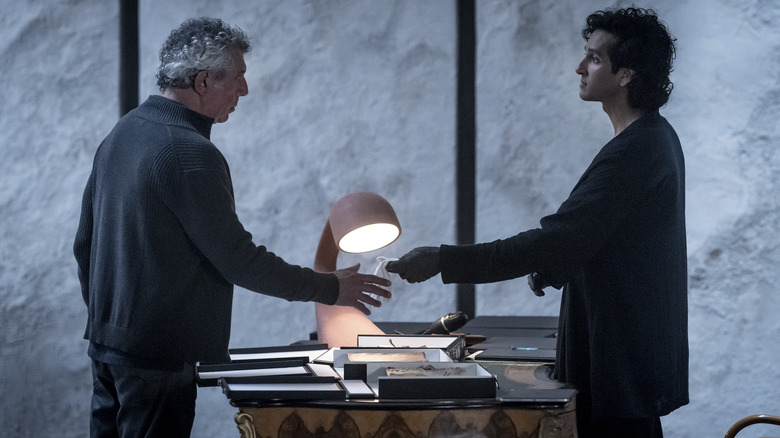 Armand hands Daniel a cloth