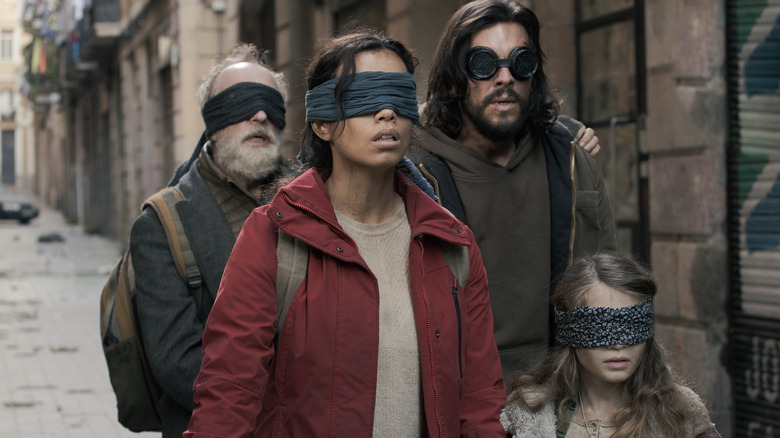 Group avoiding Bird Box monsters