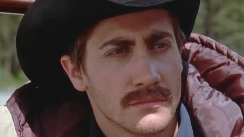 Jake Gyllenhaal staring while wearing a cowboy hat in Brokeback Mountain