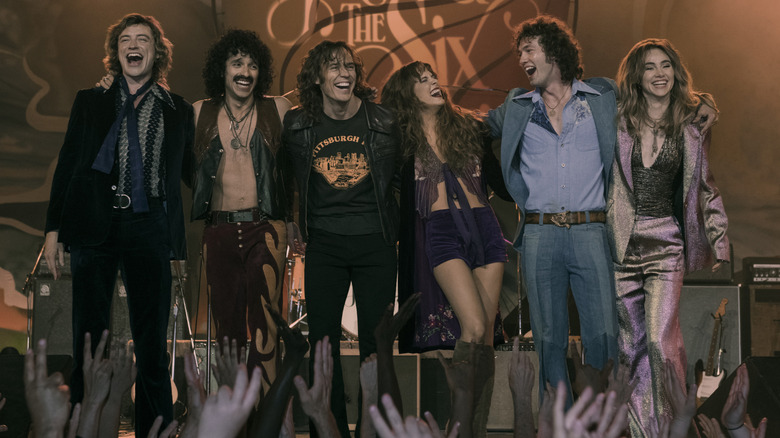 Daisy Jones & the Six performing smiling laughing