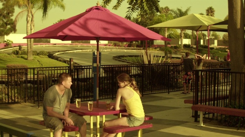 Mike and Brooke sit at a table and talk