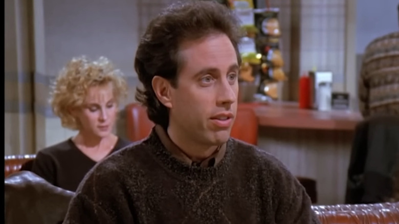Jerry Seinfeld sitting at Monk's Diner