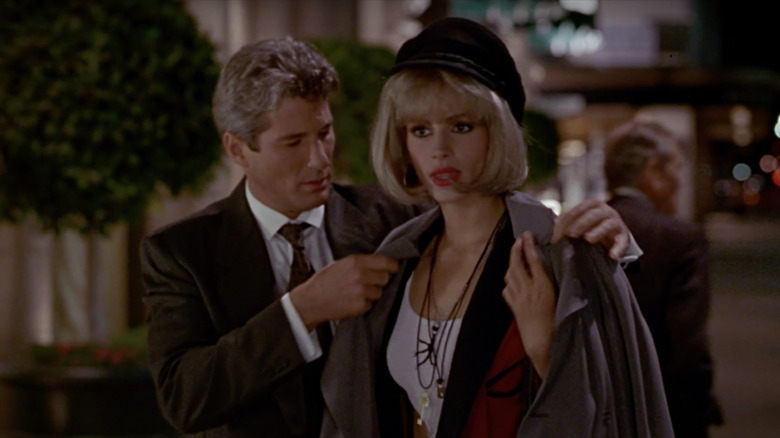 Edward putting coat Vivian