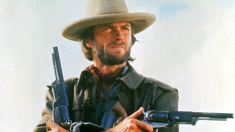 Josey Wales crosses arms with guns in hands