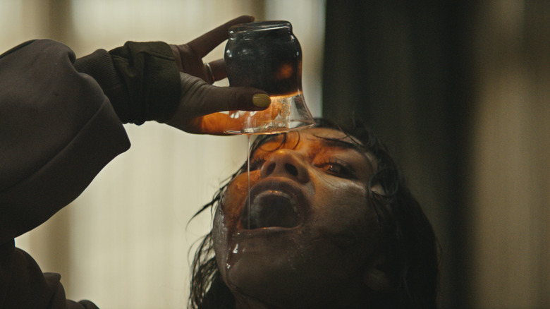 Deadite Thya drinks hot candle wax in "Evil Dead Burn" (2026)