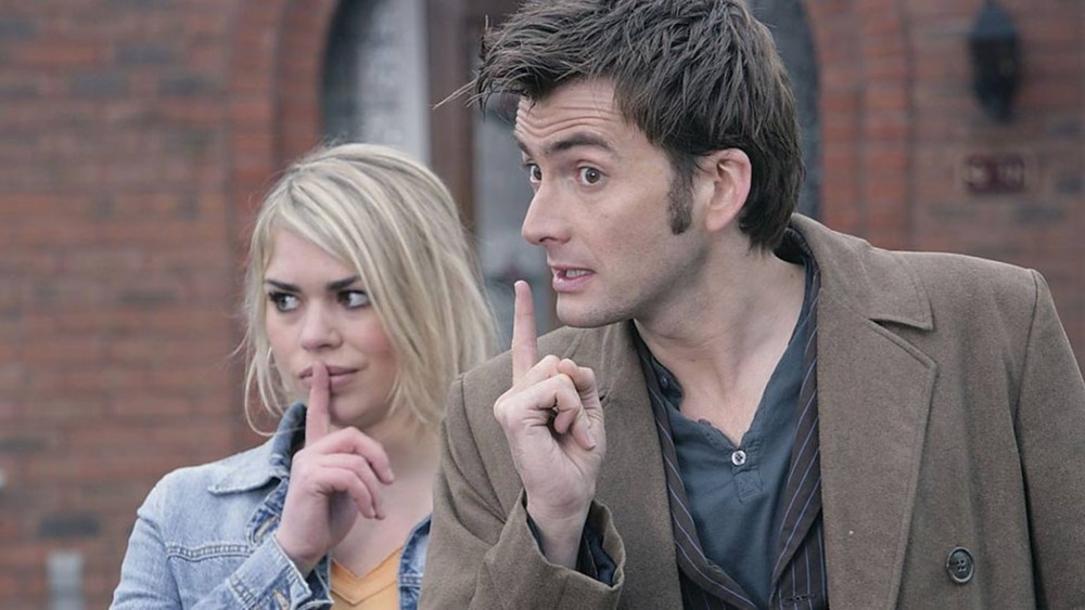 The Doctor (David Tennant) and Rose (Billie Piper) shush someone on Doctor Who