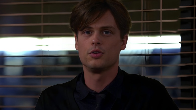 Spencer Reid speaking in front window