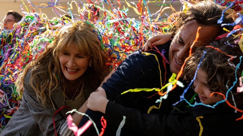 Tess, Alex, and one of their sons are surrounded by confetti in 