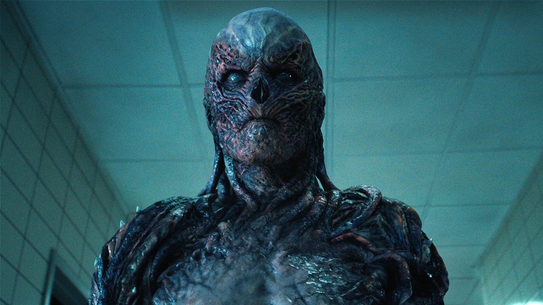 Vecna looking scary in a hallway in "Stranger Things"