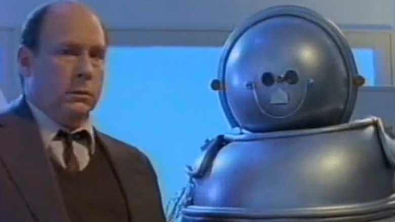 Man and robot looking at camera in Isaac Asimov's Robots (1988)