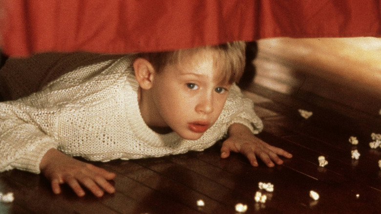Kevin hides under the bed in Home Alone (1990)